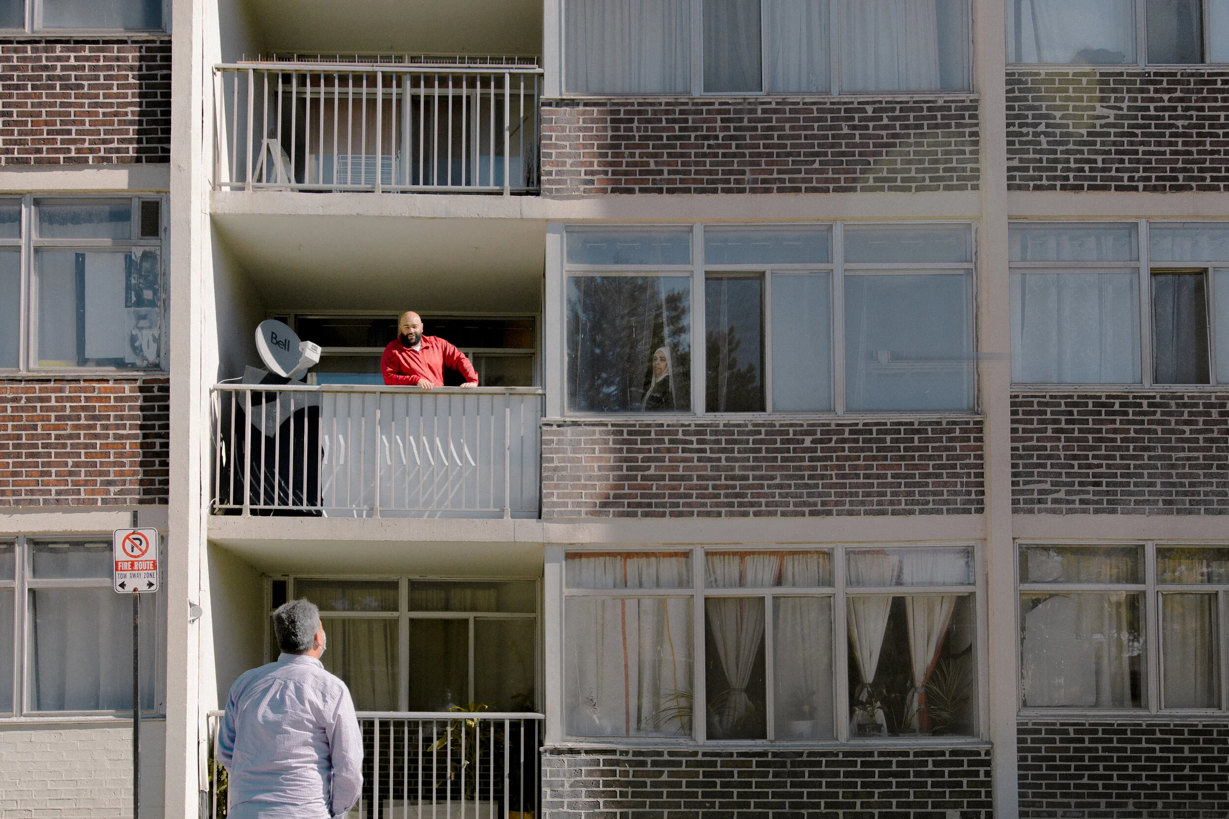 Photographed in Scarborough, Qais who lives on the 8th floor comes down to meet Yusuf outside of his 2nd floor balcony. “We actually used to meet like this often earlier in the pandemic.” Qais says. 
Balconies have become the meeting place for many 